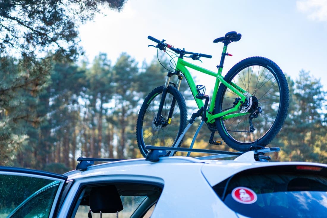 Several bicycles loaded on a rear-mounted car rack