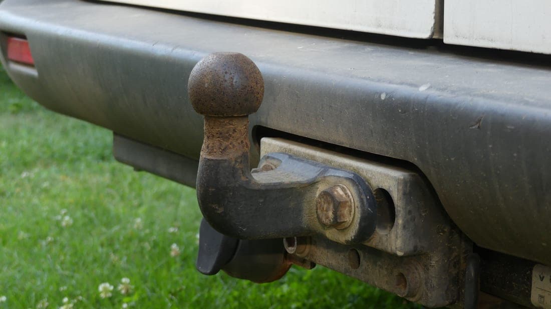 A steel cargo basket mounted in the hitch receiver of an SUV