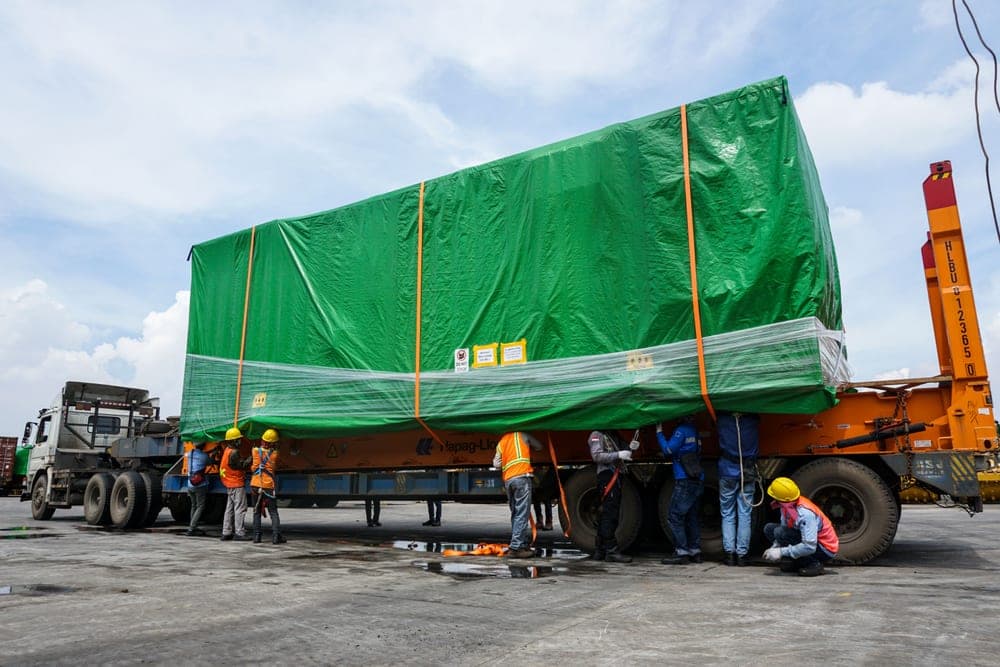 An elasticated cargo net stretched over a loaded basket