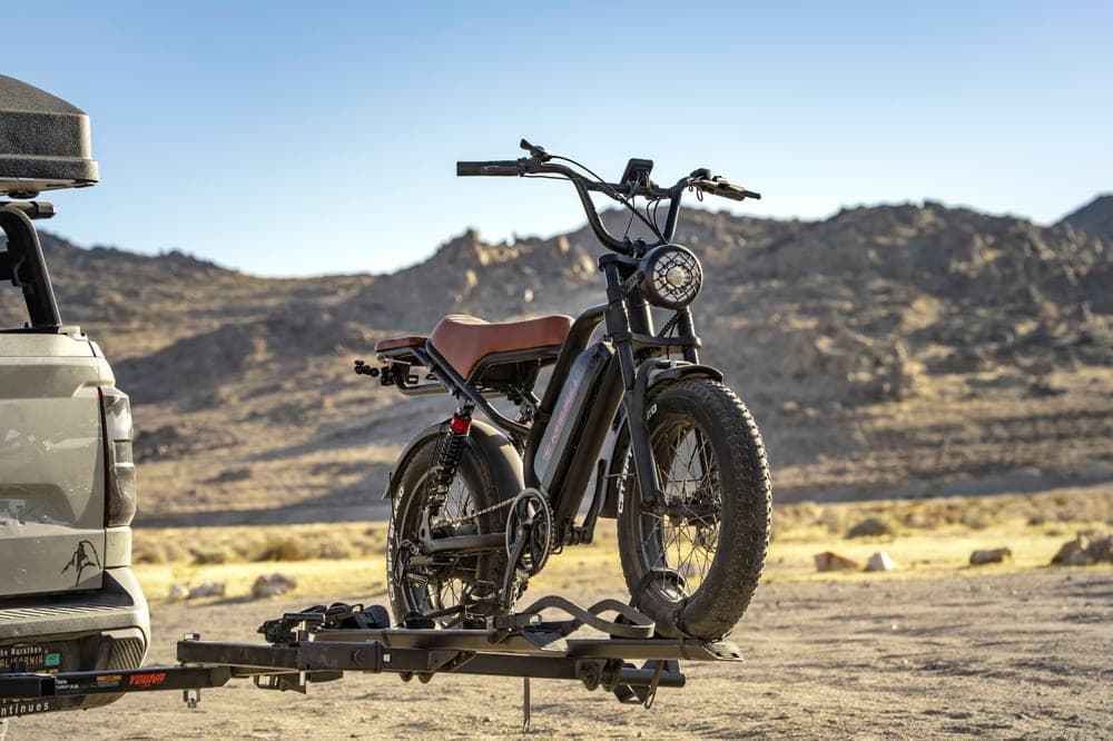 A platform hitch bike rack carrying two mountain bikes behind a vehicle