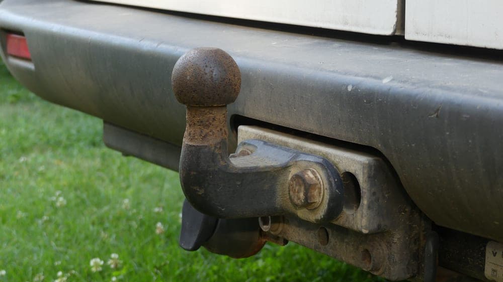 A tow hitch receiver fitted beneath the rear bumper of an SUV