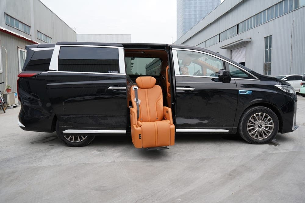 A minivan parked outside a house, side door open